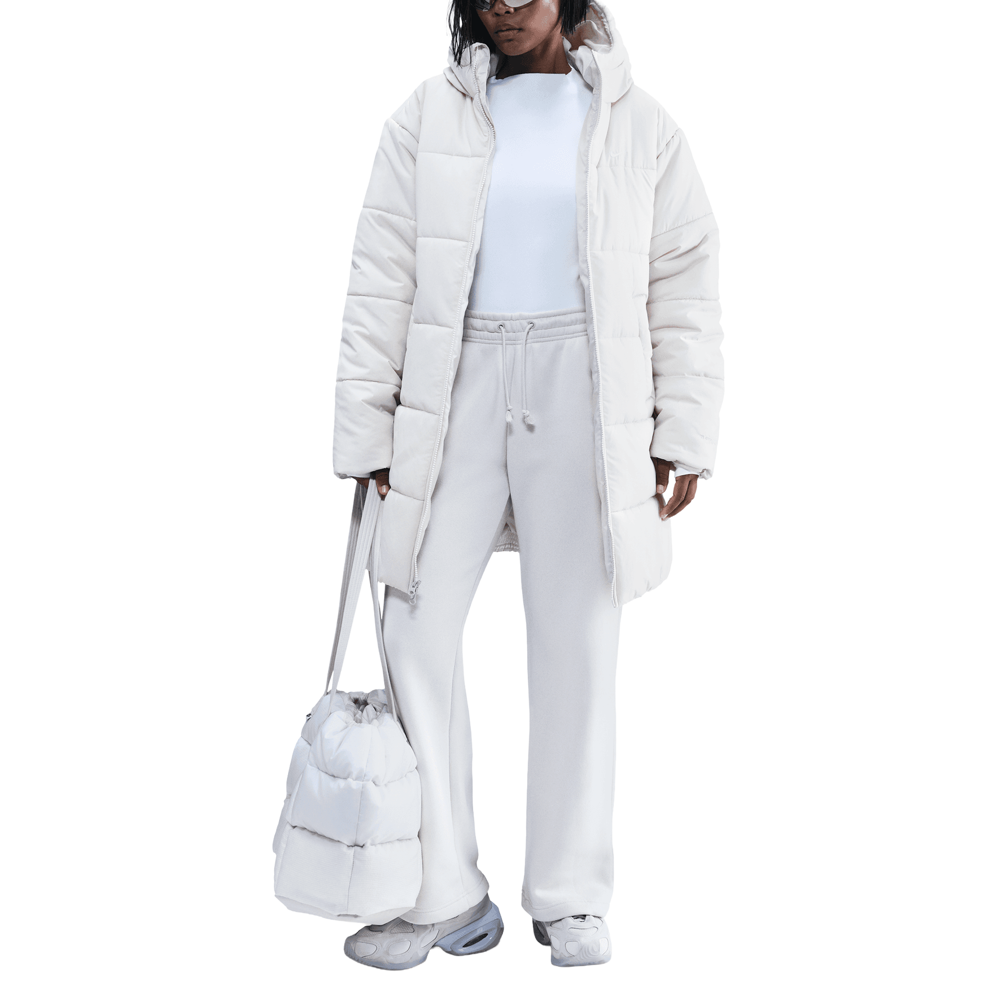 Front of zip tote bag with white canvas, black canvas straps and handle, and black zipper pulls.